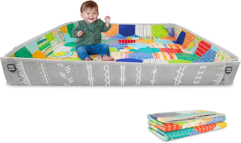 Play Mat: image of a baby play gym set up outdoors in a garden or park, demonstrating its outdoor suitability.