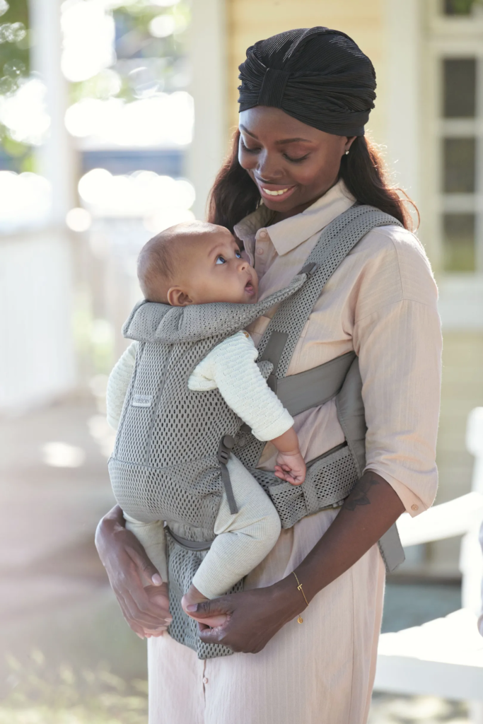 Baby Carrier: a BabyBjörn carrier being used in an outdoor setting, highlighting its portability.