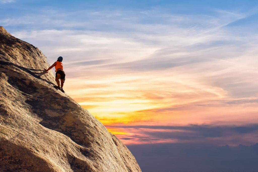 Image of a person climbing a mountain or overcoming an obstacle: This symbolize resilience and strength.