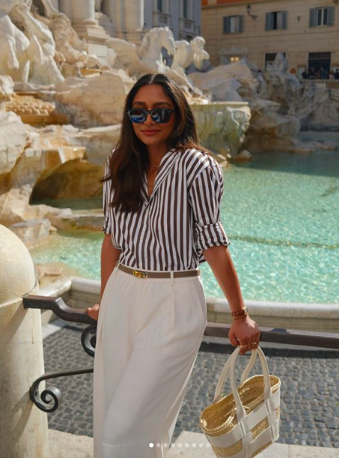 Image of a woman wearing a stripe shirt with white pants.