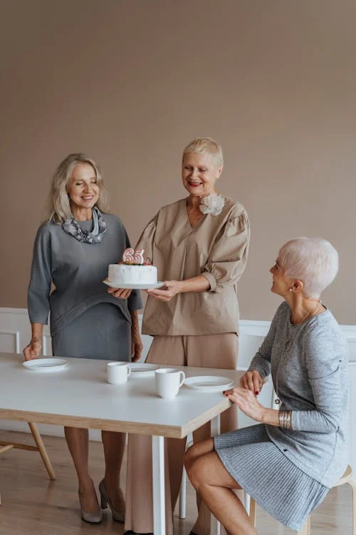 Effortless Style: A group of elderly women in monochromatic outfit in shades of beige or grey.