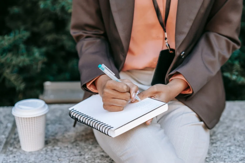 Image of a person writing in her diary